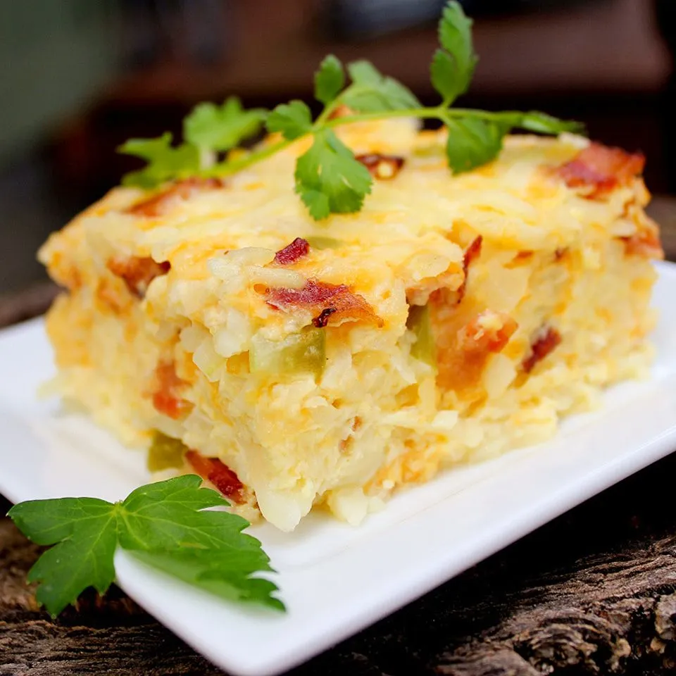 A breakfast plate with bacon and cheese.